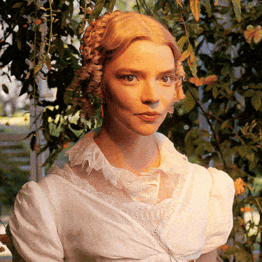 a woman in a white dress with a braided bun