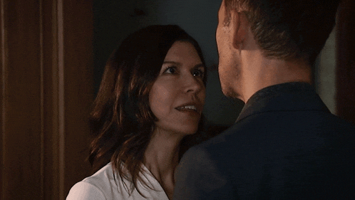 a man and a woman are looking at each other with their eyes closed