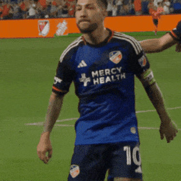 a soccer player wearing a jersey that says mercy health on it