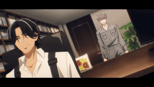 a man sitting at a desk with a sign that says bg