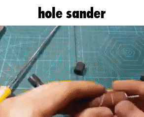 a person is using a hole sander on a cutting board .