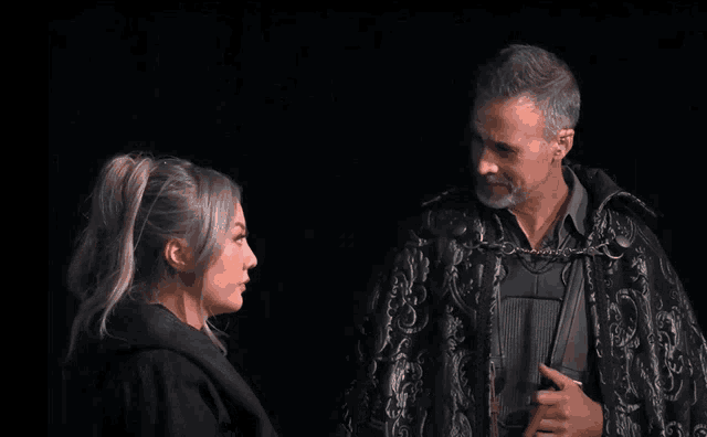 a man and a woman standing next to each other