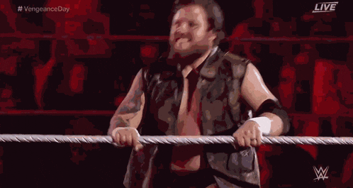 a wrestler is standing in a ring with the words live on the bottom