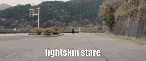a person walking down a road with the words lightskin stare written below them