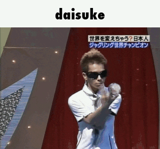 a man wearing sunglasses and a white shirt is holding a ball in front of a red curtain and the word daisuke is above him