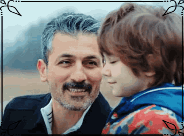 a man with a beard is holding a young boy