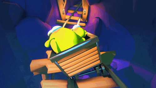 a green frog is sitting in a wooden cart in a cave