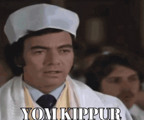 a man wearing a chef 's hat with the words yom kippur on it