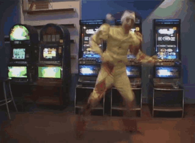 a man is jumping in the air in front of a slot machine that says ' lucky ' on it