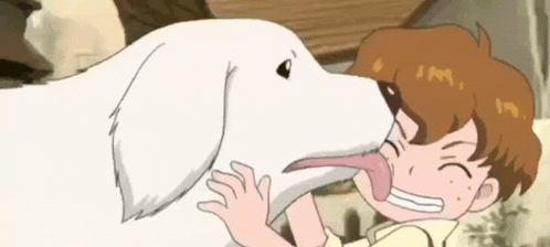 a boy is licking a dog 's nose with his tongue