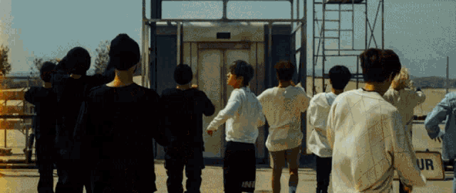 a group of people standing in front of a sign that says ur on it
