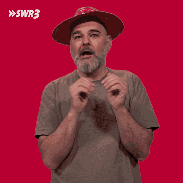 a man with a beard wearing a red hat with swr3 written on it