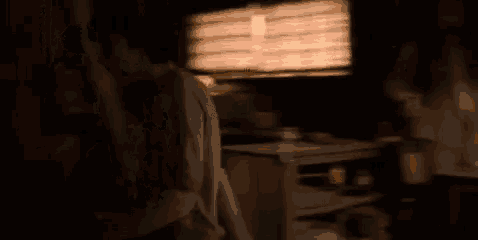 a blurry picture of a man standing in a dark room with a window .