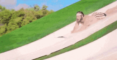 a man is sliding down a water slide in a water park .