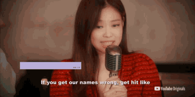 a woman singing into a microphone with the words " if you get our names wrong get hit like "