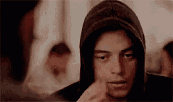 a close up of a man wearing a hoodie and looking at something .
