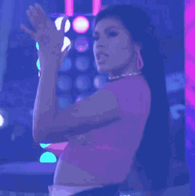 a woman in a pink crop top is dancing