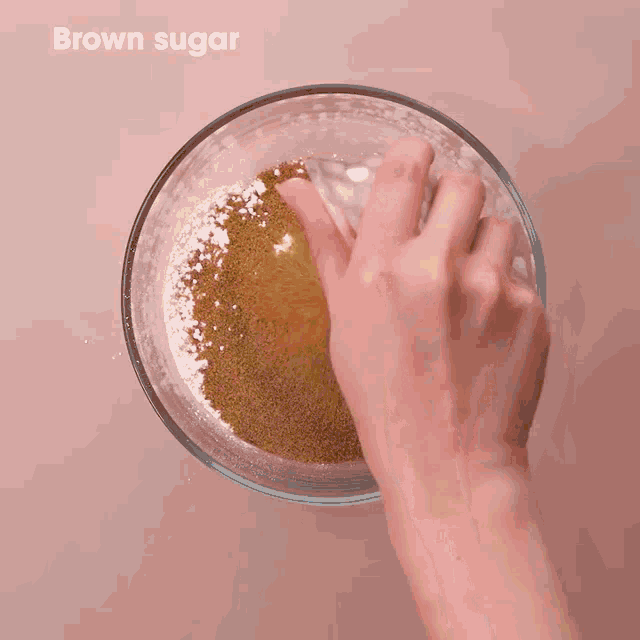 a person is holding a ball in a glass bowl .