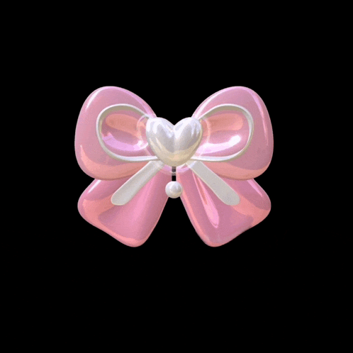 a pink bow with a heart and pearls on it