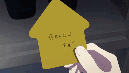 a person is holding a piece of paper with chinese writing