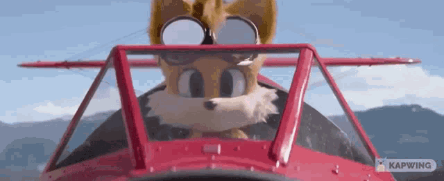 a cartoon fox wearing goggles is sitting in a red plane .