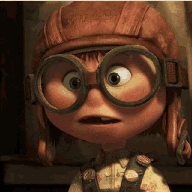 a cartoon character wearing a helmet and goggles with a badge that says ' up '