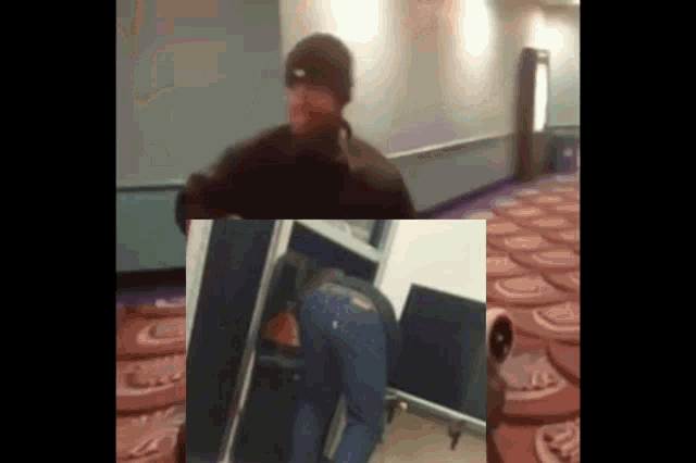 a man in a black hat is standing in a room with a purple carpet