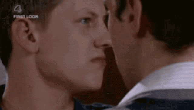 a close up of two men 's faces with the first look logo on the bottom
