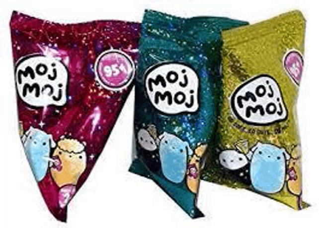 three bags of moj moj candy are sitting on top of each other on a white surface .