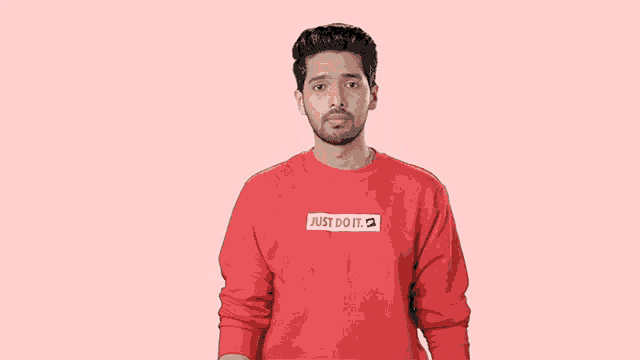 a man wearing a red just do it shirt