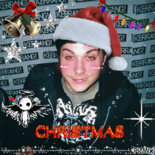 a man wearing a santa hat with the word christmas written on it