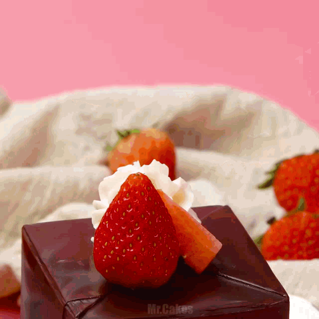 a chocolate cake with whipped cream and strawberries on top