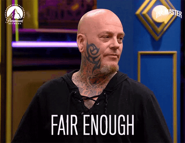 a bald man with a beard and tattoos on his face says fair enough