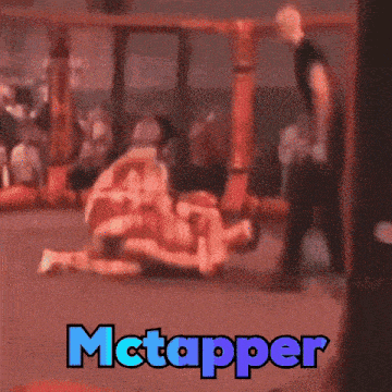 a picture of two men wrestling with the word mctapper in the corner