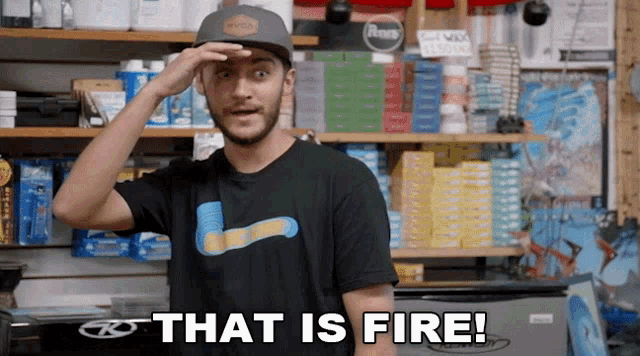 a man wearing a hat and a black t-shirt says that is fire