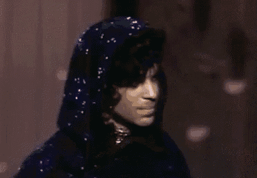 a close up of a person wearing a hooded cape .