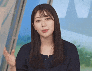 a woman with long hair and bangs is wearing a black dress