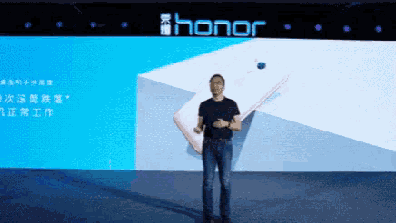 a man is standing in front of a large screen with the word honor on it