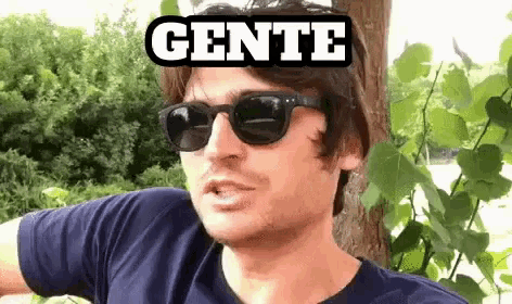 a man wearing sunglasses has the word gente written on his head