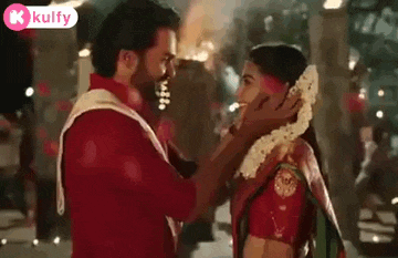 a man is putting a garland on a woman 's head .