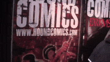 a sign for hounscomics.com shows a woman holding a sword