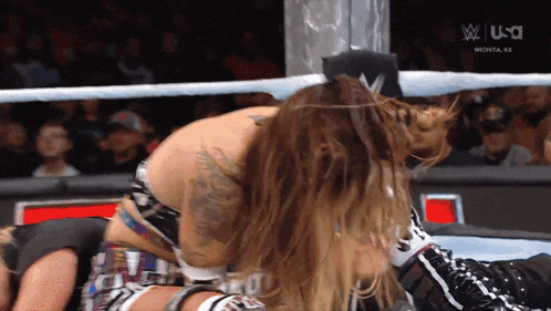 two women are wrestling in a ring with the usa logo on the bottom left