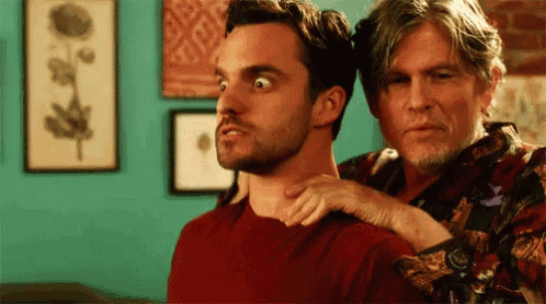 two men are standing next to each other in a room . one of the men is giving the other a massage .