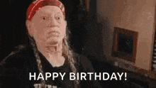 willie nelson is wearing a red bandana and a black shirt and says `` happy birthday ! ''