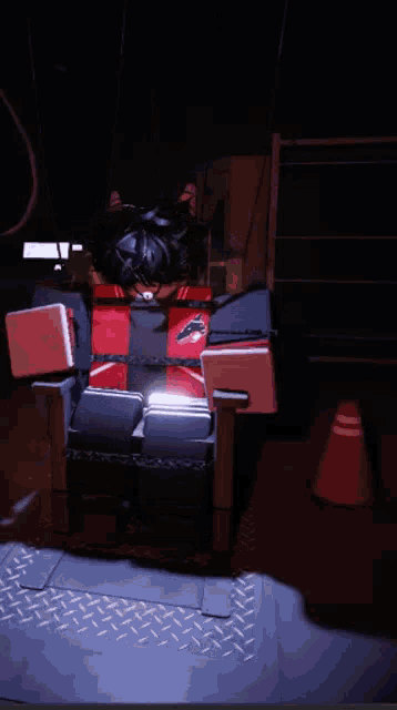 a red and black chair with a picture of a person sitting in it