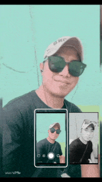 a man wearing sunglasses and a hat is taking a selfie