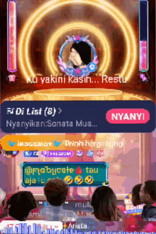 a group of people sitting in front of a screen that says nyanyi on it