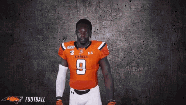 a football player wearing an orange jersey with the number 9