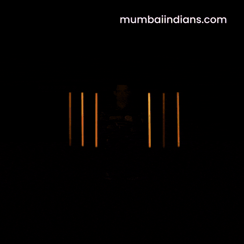 a man wearing a blue shirt that says ' mumbai indians ' on the front