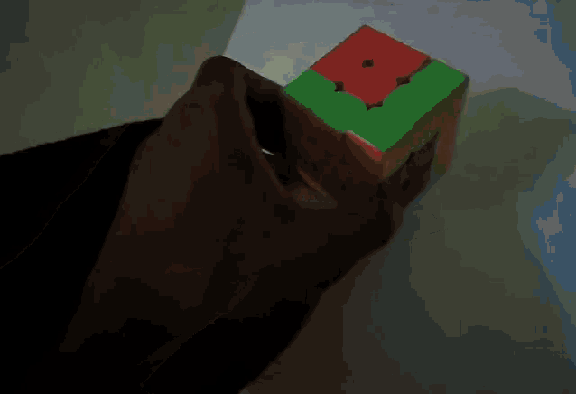 a person is playing with a colorful cube that has a square in the middle
